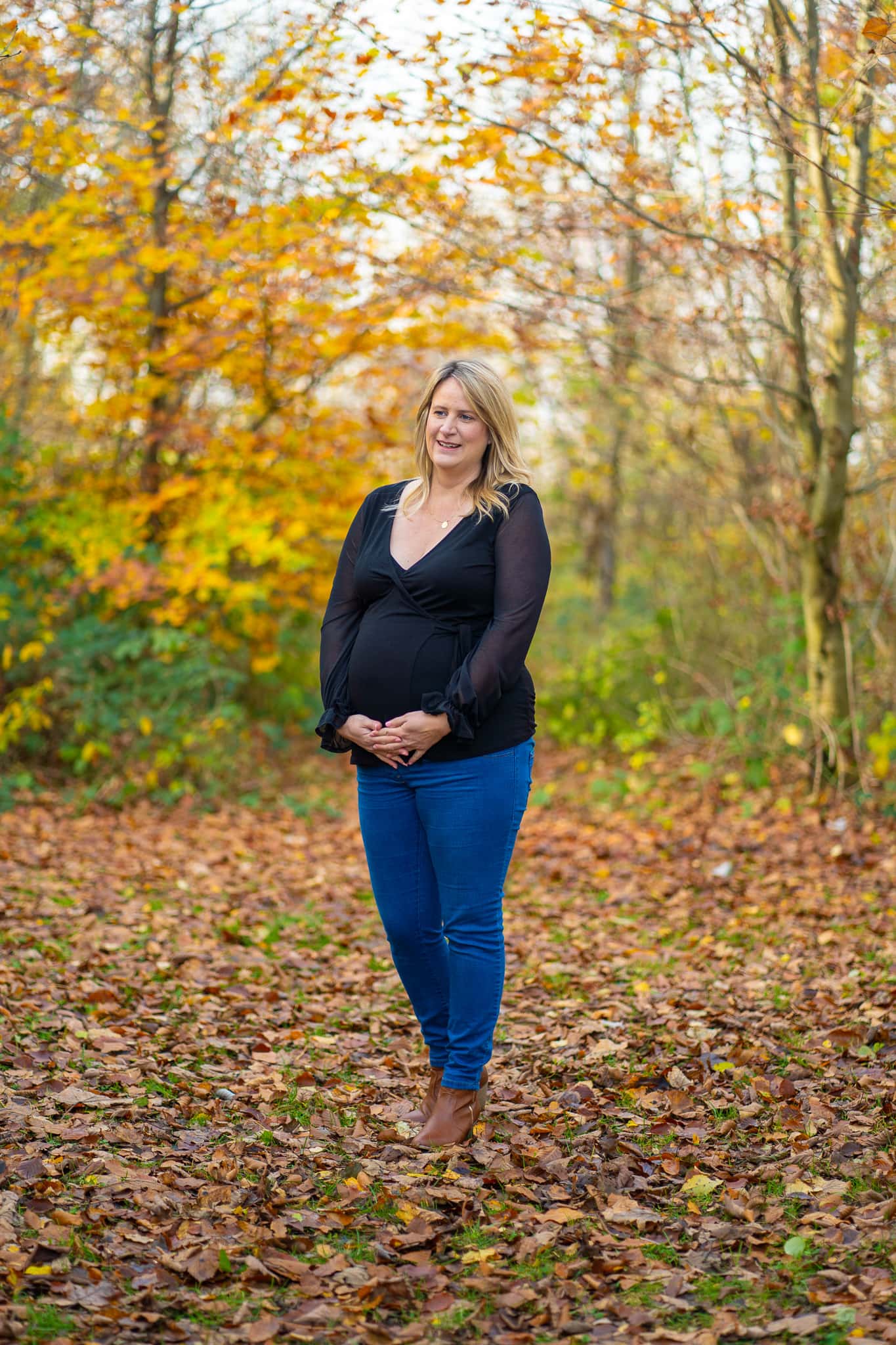 Mum to be holding her bump on a Maternity Shoot
